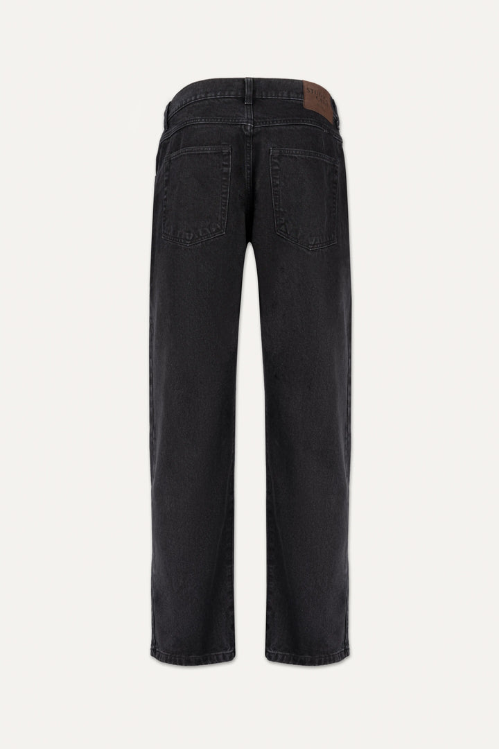 A close-up of coal black denim fabric showing the texture and signature bartack stitching.