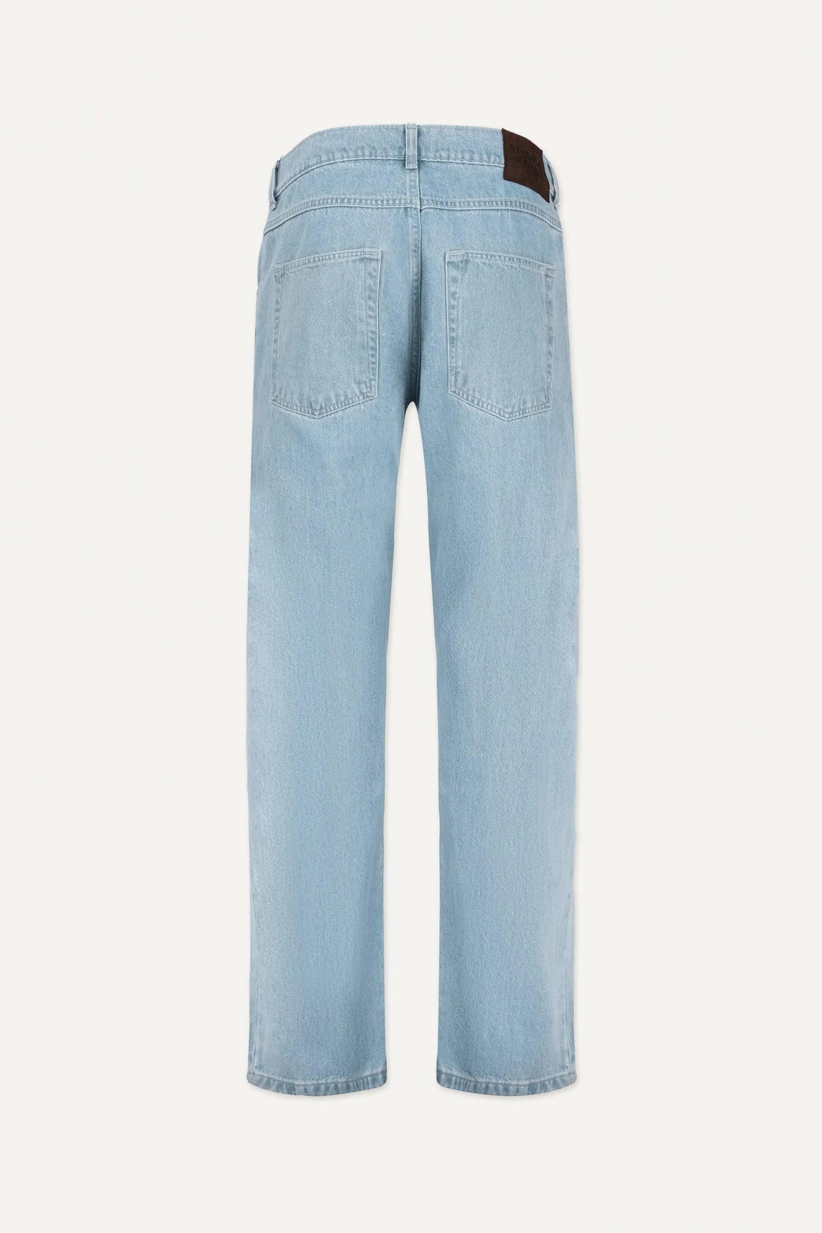 A close-up of light blue denim fabric showing the texture and signature bartack stitching.