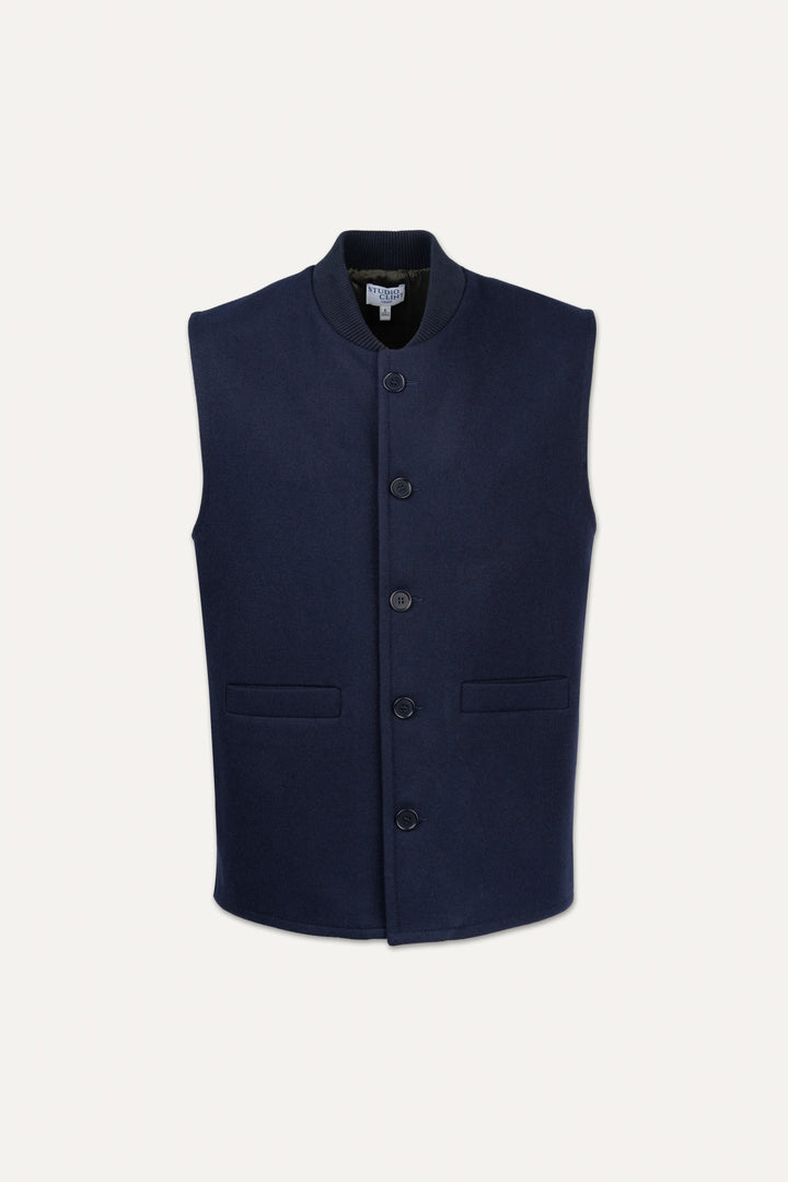 A sleeveless navy blue waistcoat with a mandarin collar, front button closure, and two front flap pockets, shown against a light off-white background.